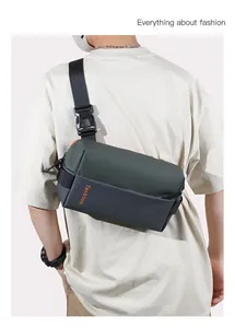 Detail of army green and grey crossbody bag with adjustable strap and fashion logo