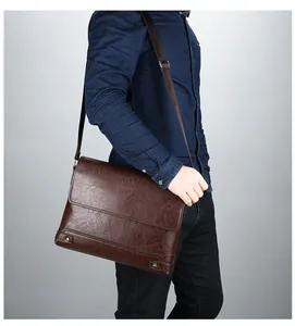 Detail of a dark brown leather briefcase with adjustable strap and vintage flap design