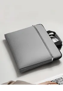 Close-up of waterproof grey Oxford fabric laptop bag with front zipper pocket and handle