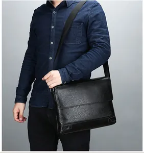 Men's black faux leather briefcase cross-body bag shown with an adjustable canvas strap