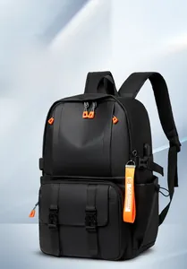 Detail of black waterproof backpack featuring bright orange decorative straps and buckles