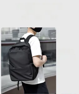 Detail view of stylish black laptop backpack with wide padded straps in blue black and grey