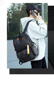 Close-up of black tactical backpack with durable nylon fabric and orange zipper accents