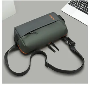 Detail of waterproof nylon crossbody bag with fashion print and orange zipper accent