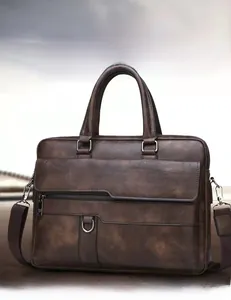 Detail of premium brown head cowhide leather texture and silver hardware on business bag