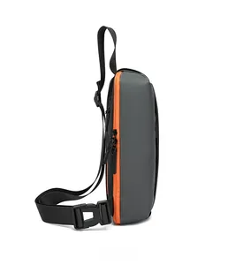 Side view of gray crossbody chest bag featuring a vibrant orange zipper and buckle detail
