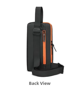 Back view of sporty black nylon chest bag with orange zipper and adjustable strap