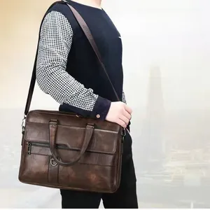 Detailed view of dark brown cowhide briefcase leather texture and metal zipper