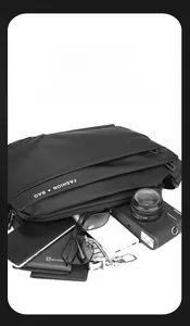 Spacious black messenger bag detail showing multi-compartment storage for tech and EDC gear