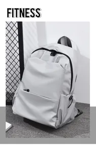Detail view of water-resistant light gray backpack with side drawstring pocket and zipper