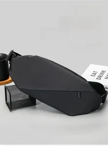 Close-up of black waterproof crossbody sling bag with geometric techwear design and hidden zip