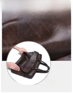 Detail of waterproof and scratch-resistant dark brown leather texture on business briefcase