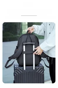 Detail of black travel backpack with integrated luggage strap for suitcase attachment