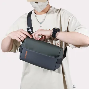 Mens color-block crossbody chest bag in forest green and dark grey with fashion logo