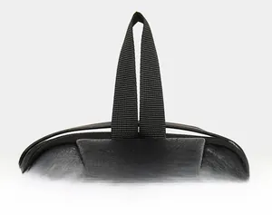 Close-up of a black leather sling bag showing the durable woven handle and fine texture