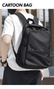 Outdoor back view of a minimalist black large capacity nylon backpack for students