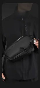 Detail of black tactical crossbody bag showing side mesh pocket holding a water bottle