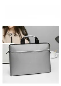 Detailed view of the water-resistant light grey laptop bag with front zipper pocket