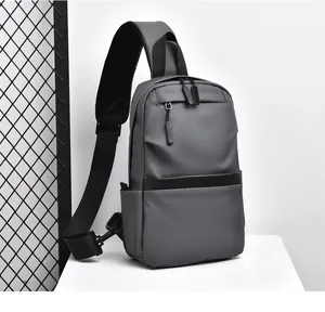Detail of dark grey water-resistant chest bag showing breathable mesh strap and zippers