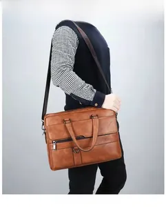Brown leather briefcase model shot showing cross-body strap and premium dual-tone texture