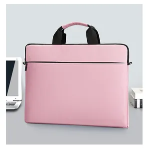 Detailed view of pink waterproof laptop sleeve with large front pocket on a desk