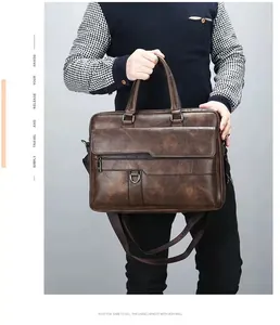 Close-up of a vintage brown business briefcase with leather handles and woven shoulder strap