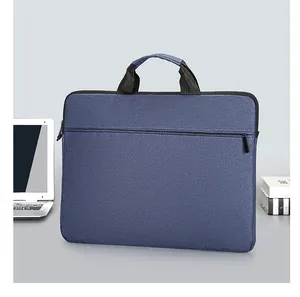 Detail view of a blue waterproof laptop sleeve showing textured fabric and front zipper pocket