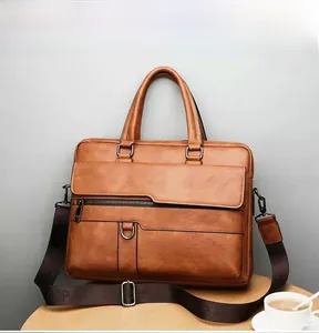 Close-up of brown leather briefcase with adjustable strap on a professional wooden desk