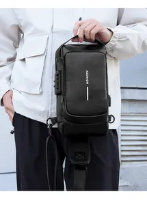 Detail of men's leather crossbody bag featuring anti-theft lock and USB charging port