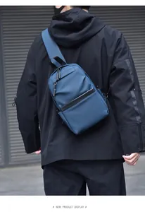 Waterproof navy blue crossbody chest bag shown on model with adjustable wide shoulder strap