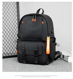 Detail of backpack with orange zipper pulls and external USB charging port