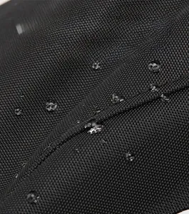 Close-up of waterproof black high-density nylon fabric with clear water droplets