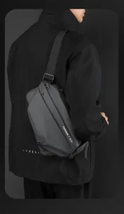 Detailed view of matte waterproof crossbody bag featuring a magnetic buckle and fashion text