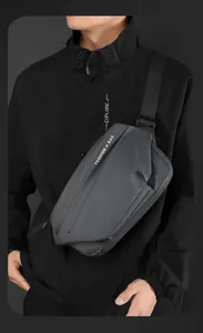 Detail of waterproof matte fabric and fashion text on dark grey crossbody chest bag