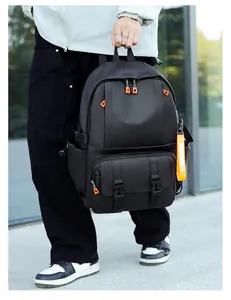 Detail of waterproof nylon backpack featuring orange zippers and functional side straps