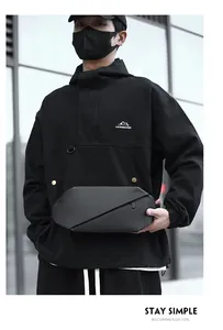 Detail of waterproof nylon chest bag with geometric folding design and matte finish