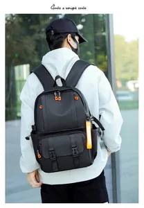 Outdoor shot of a black large capacity laptop backpack with stylish orange accents