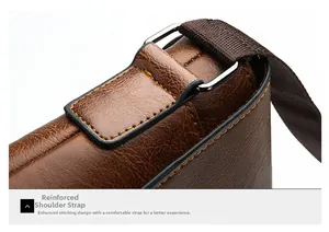 Close-up of reinforced shoulder strap stitching on brown leather business briefcase