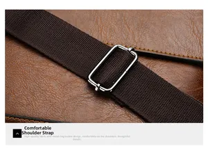 Detail of adjustable metal buckle and woven strap on vintage leather briefcase