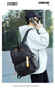 Detail of black leisure backpack featuring vibrant orange zipper pulls and side buckles