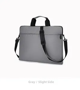 Slight side view of grey waterproof Oxford cloth laptop bag with handle and shoulder strap