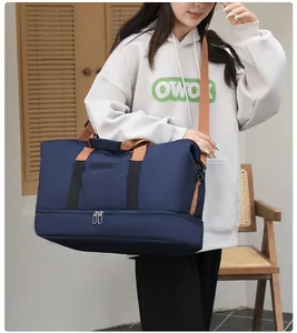 Detalle de bolsa de viaje azul con compartimento inferior para zapatos y correas ajustables