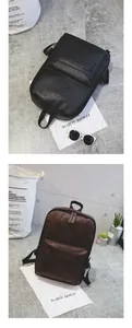 Detail of black and brown PU leather backpacks with diamond patch on grey background