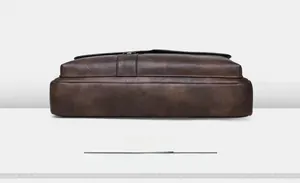 Detailed bottom view of brown business briefcase showing premium synthetic leather texture