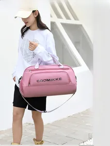 Close-up of pink fitness bag with logo and front zipper pocket for travel and yoga
