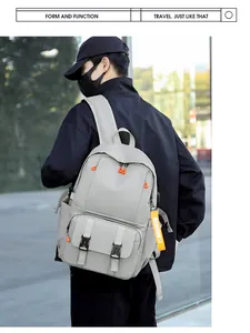 Outdoor shot of light grey large capacity travel backpack with orange zipper details