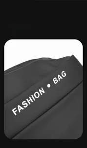 Close-up of waterproof nylon material and white Fashion Bag text on black crossbody bag