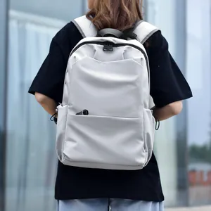 Minimalist light gray business laptop backpack with ergonomic straps shown in outdoor setting