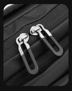 Detail shot of the dual-metal zippers and waterproof matte fabric on the crossbody bag