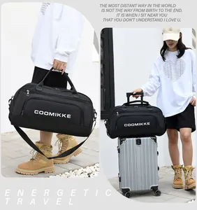 Detail of black travel bag with sturdy handles and adjustable shoulder strap for fitness